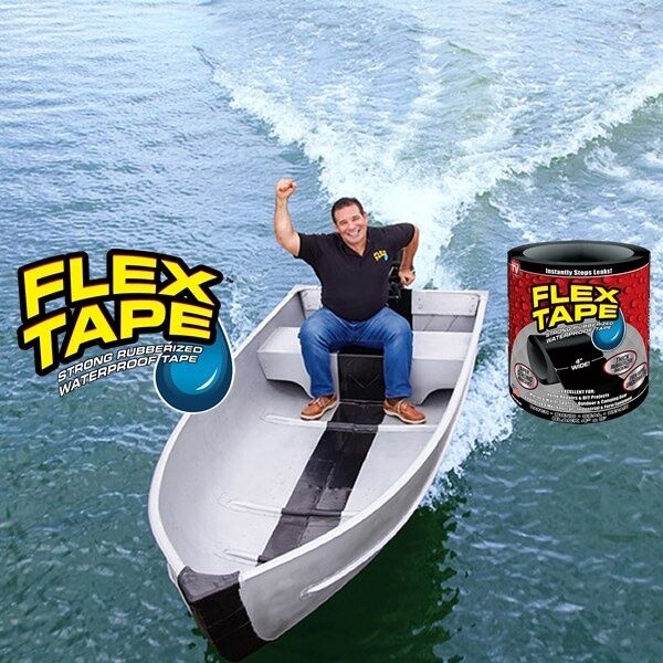 A man in a small aluminum boat speeding across open water, fist raised. The boat was cut in half and is held together with black Flex Tape.